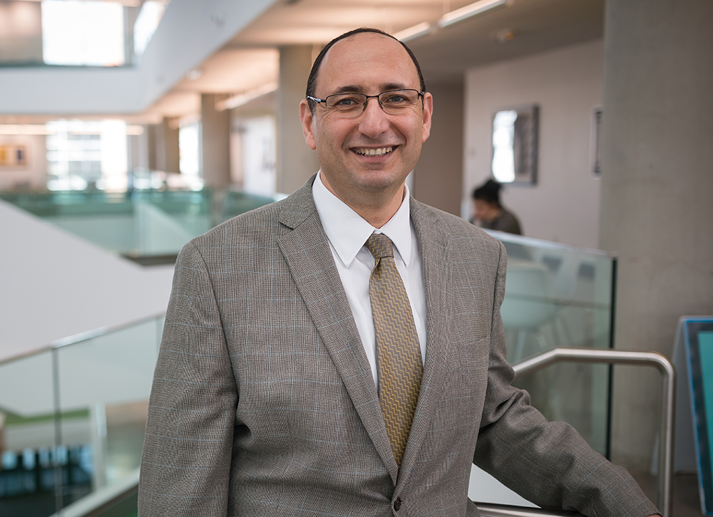 Dr.Elbarrad standing in art building in MacEwan University